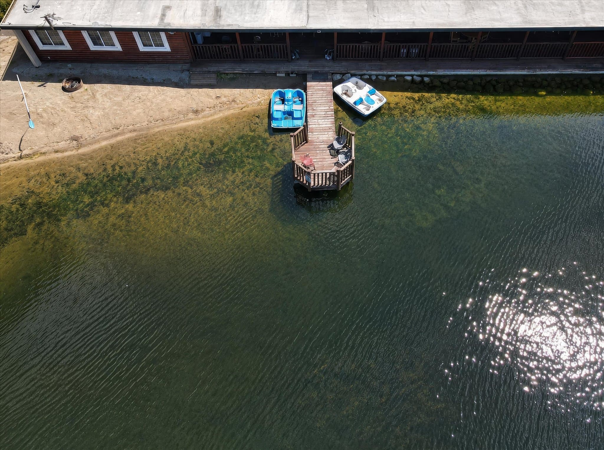 Lakefront setting and covered deck at Olde Mill Inn of Clarkston
